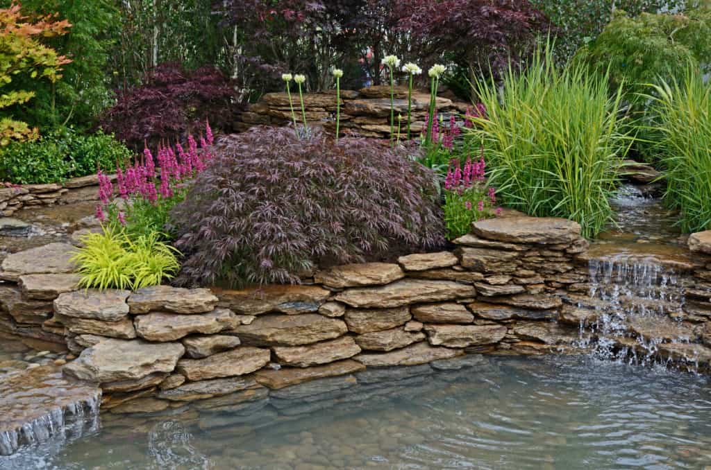 Pond on the slope with waterfall